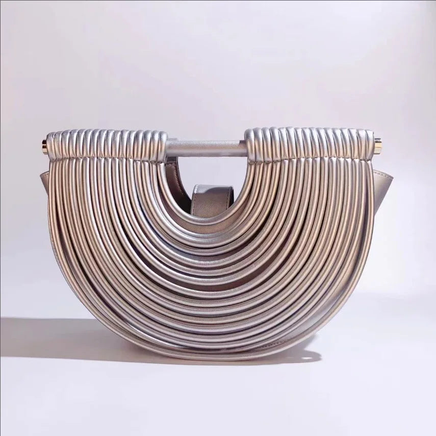 Silver clutch bag with a unique design on a white background