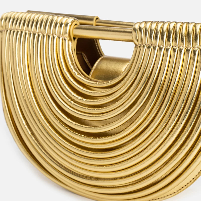 Gold clutch bag with a textured design on a white background