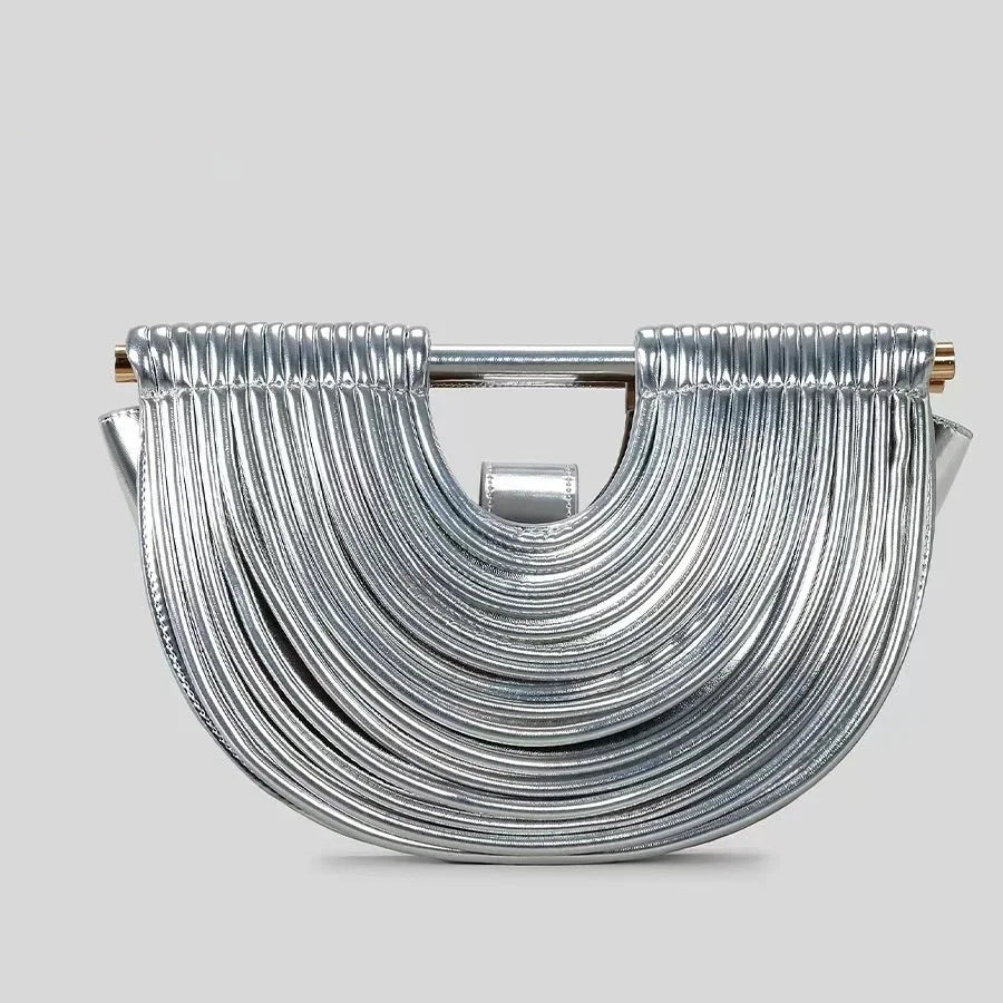 Silver handbag with a unique design on a light gray background