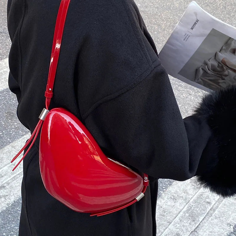 Person wearing a black coat with a red handbag and fur-lined hood.