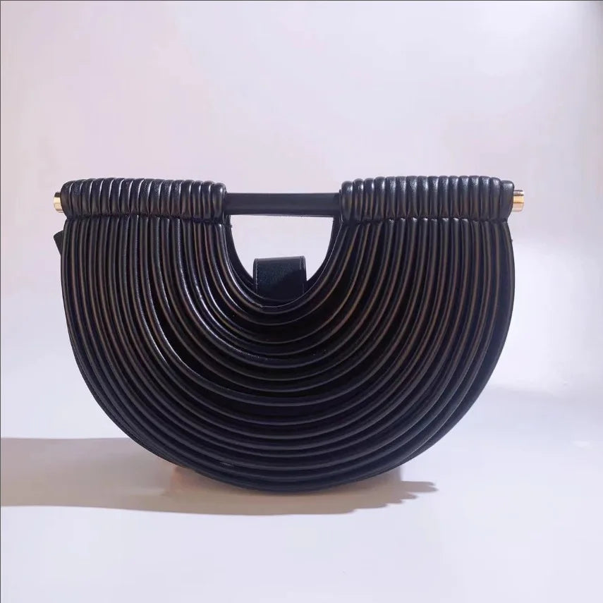 Black handbag with a unique design on a white background