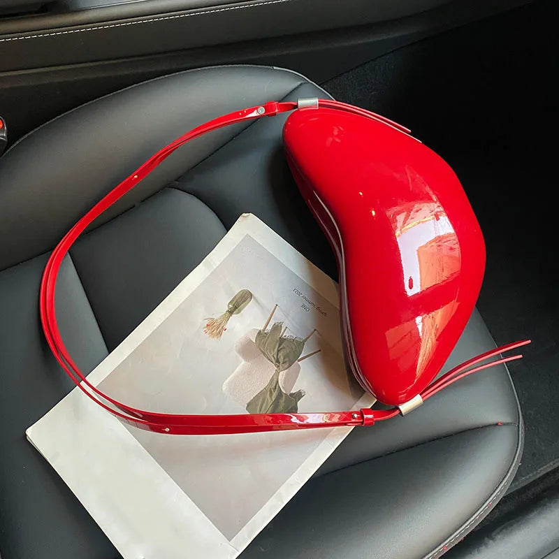 Red neck pillow on a car seat with a magazine underneath