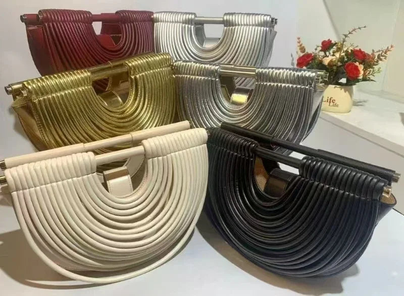 Set of four woven handbags in different colors on a white surface.