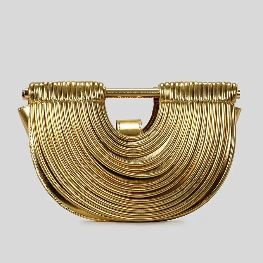 Gold clutch bag with a textured design on a light gray background