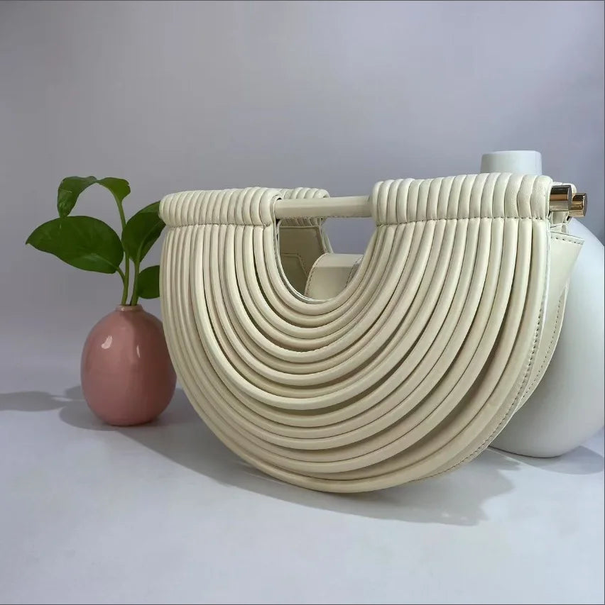 Beige handbag with a unique design on a light gray background