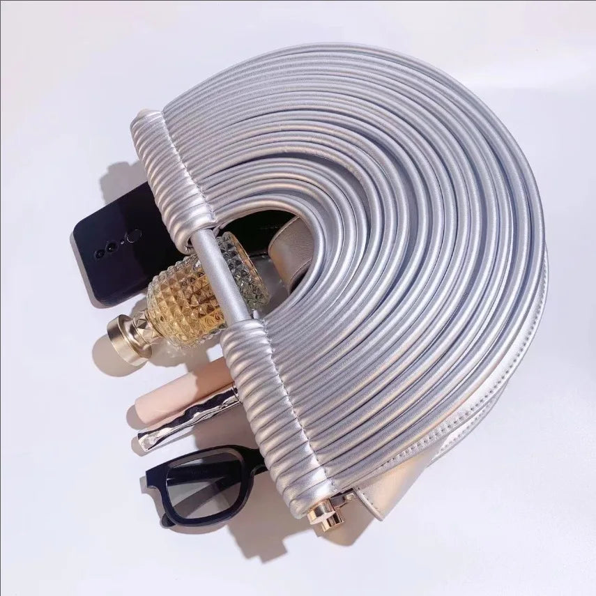 Coiled silver cable with connectors on a white background